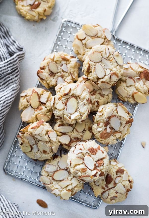 Greek almond cookies piled on a wire rack