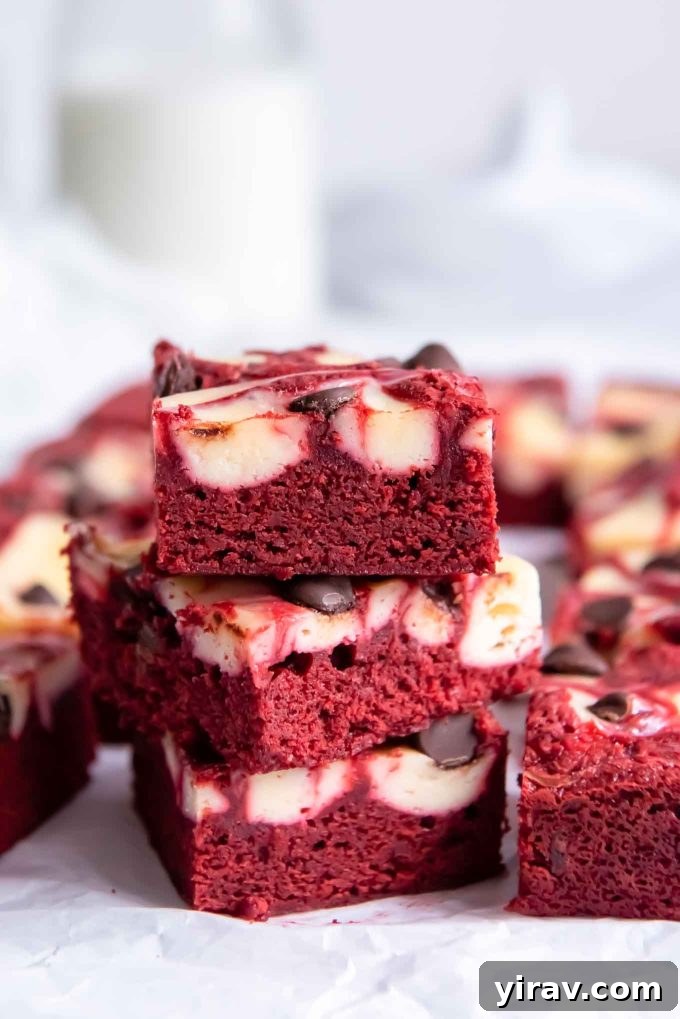 Stack of red velvet brownies with glass of milk
