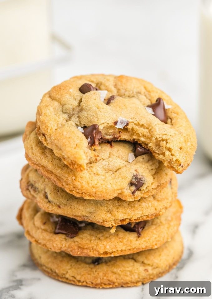 Stack of chewy chocolate chip cookies with bite out of top cookie