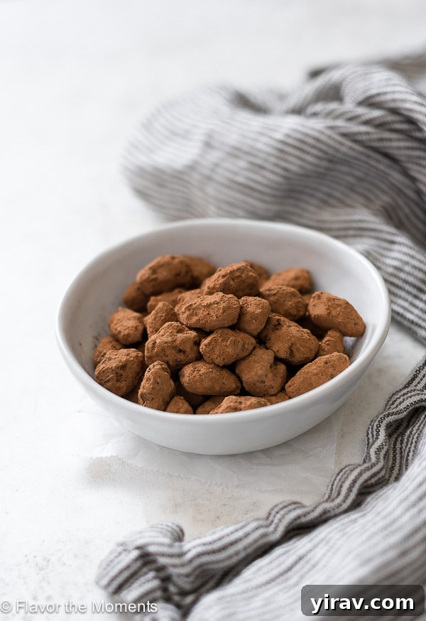 Front view of almond dragees in a white bowl with a linen