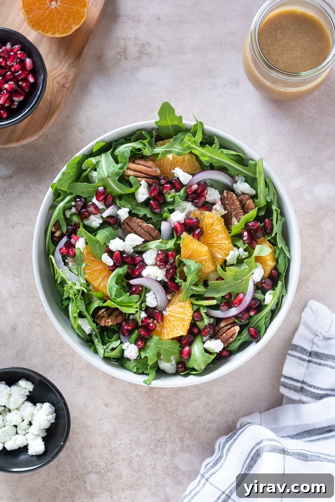 Arugula Citrus Jewel Salad 3 Arugula pomegranate salad in a bowl with pomegranate dressing and linen