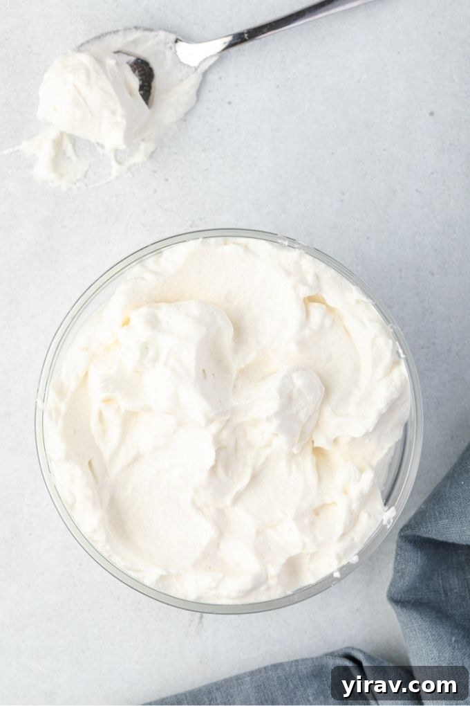 Foolproof Whipped Cream 7 Stabilized whipped cream looking light and fluffy in a glass bowl