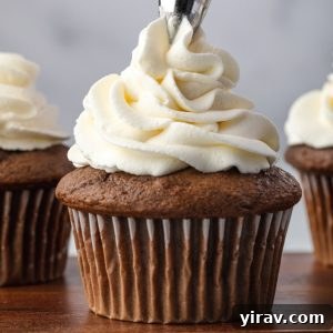 Stabilized whipped cream piping onto a cupcake
