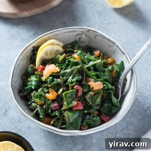 Garlicky Sautéed Swiss Chard 9 A close-up of a bowl of Sautéed Swiss Chard with lemon wedges, indicating a ready-to-eat and flavorful dish.