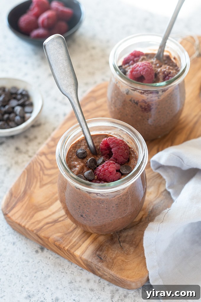 Jars of chocolate chia seed pudding with spoons digging in, highlighting the creamy texture