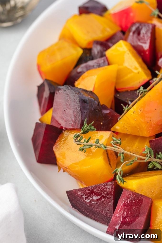 A close-up of beautifully roasted beets garnished with fresh thyme, ready to be served.