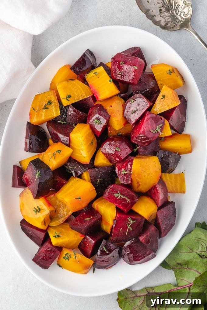 A beautiful platter of roasted beets, garnished with herbs, ready to be served.
