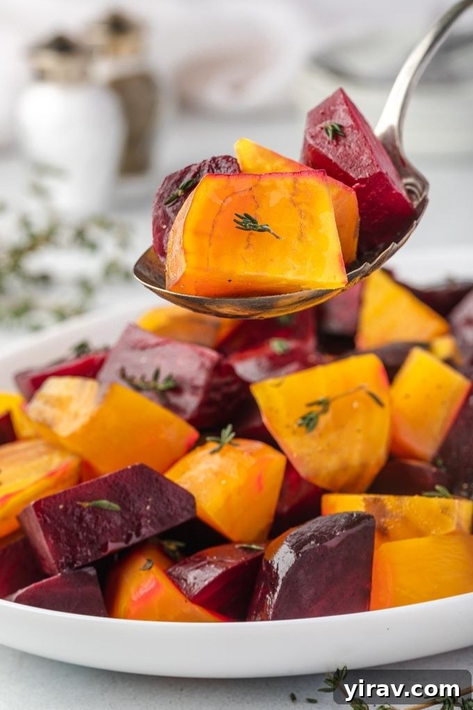 A spoonful of beautifully roasted beets over a serving plate, inviting a taste.