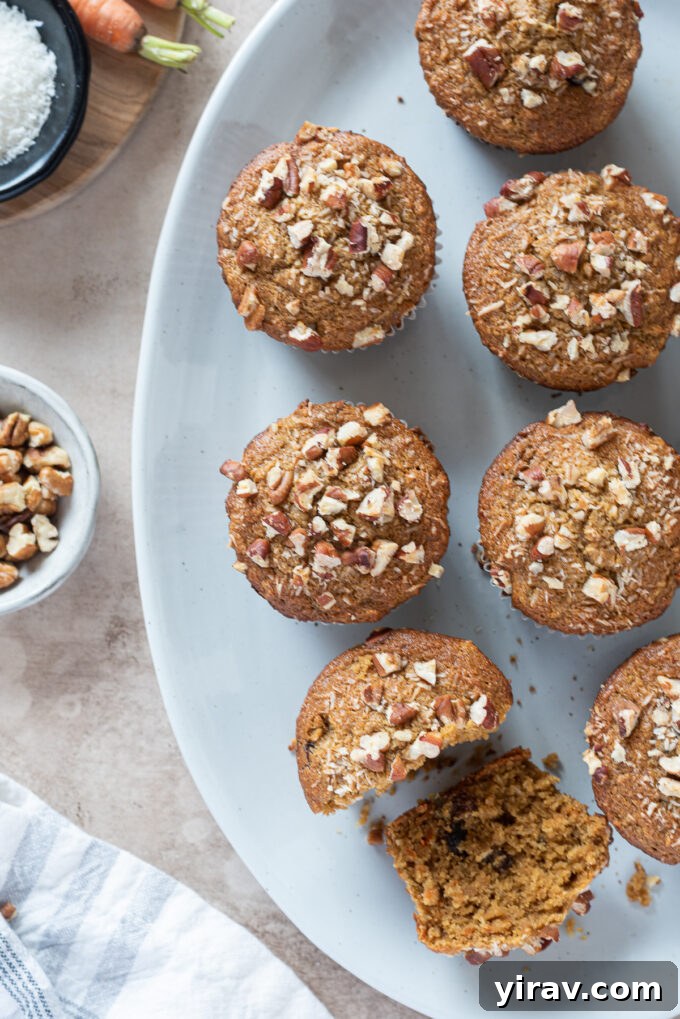 Close-up of gluten-free morning glory muffins, beautifully topped with chopped pecans, highlighting their inviting texture and rich ingredients.