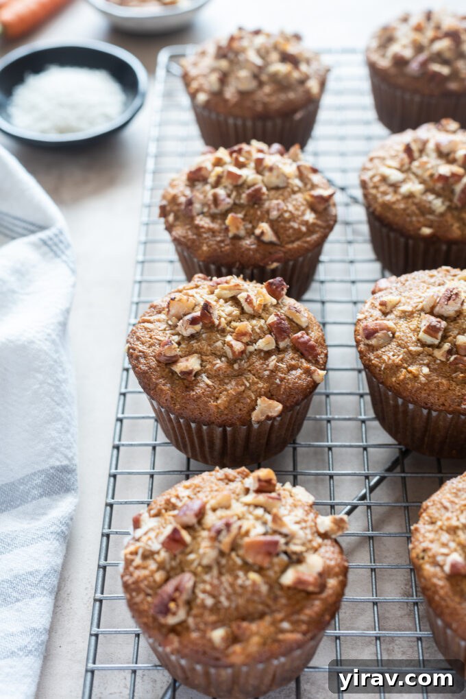 Freshly baked morning glory muffins with almond flour cooling on a wire rack, ready to be enjoyed.