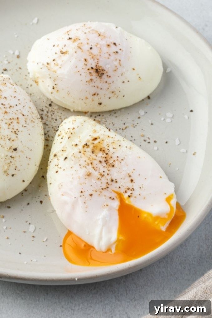 Poached egg on a plate with yolk spilling out