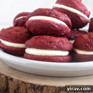 Red velvet whoopie pies piled on a plate, ready to be served.