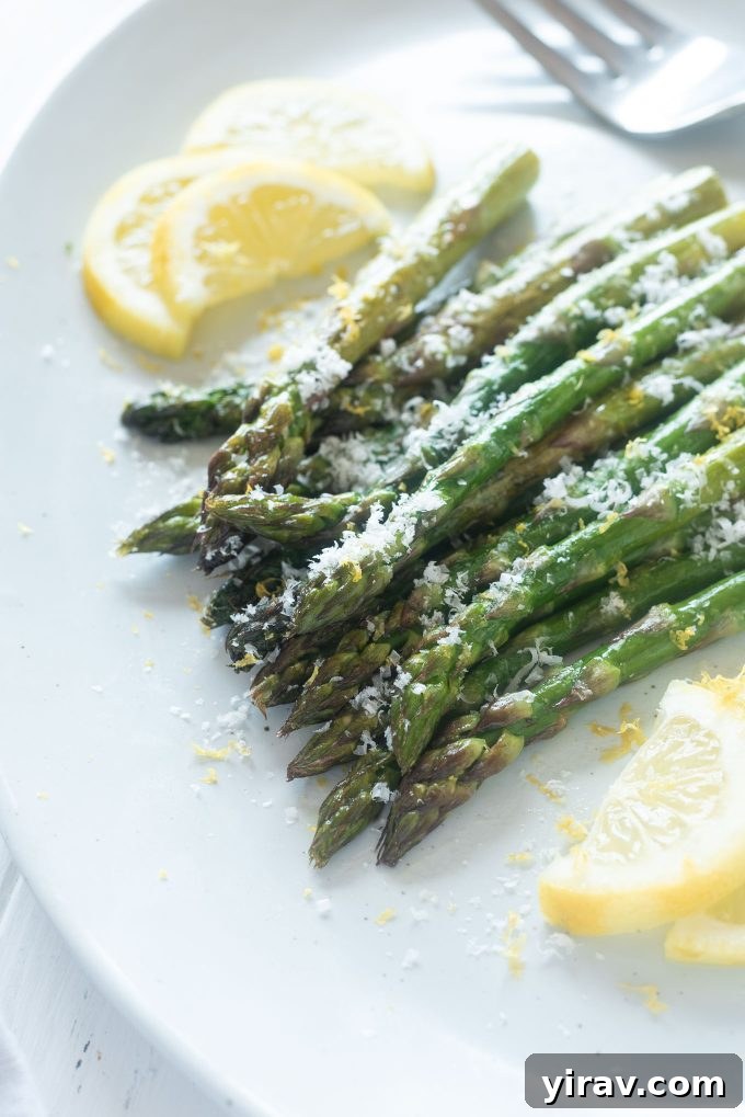 Perfectly Roasted Asparagus 2 Roasted asparagus on a platter with parmesan cheese on top
