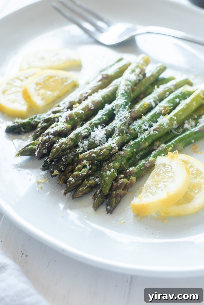 Perfectly Roasted Asparagus 3 Oven roasted asparagus on a platter with lemon slices