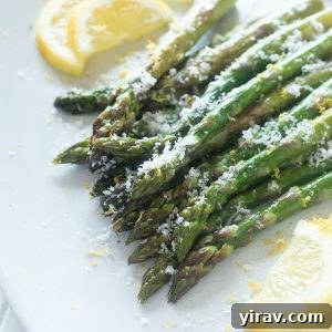 Roasted asparagus on a platter with parmesan cheese on top