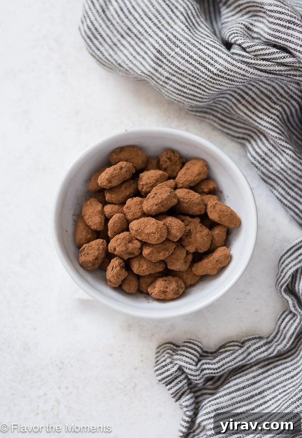 Sugar-Coated Almonds 3 Overhead shot of almond dragees in a white bowl with a linen