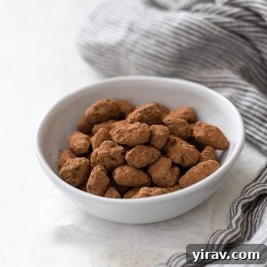 Front view of almond dragees in a white bowl with a linen