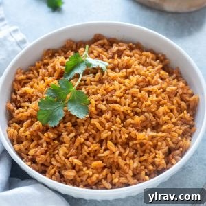 Easy Mexican rice in white serving bowl, garnished with cilantro
