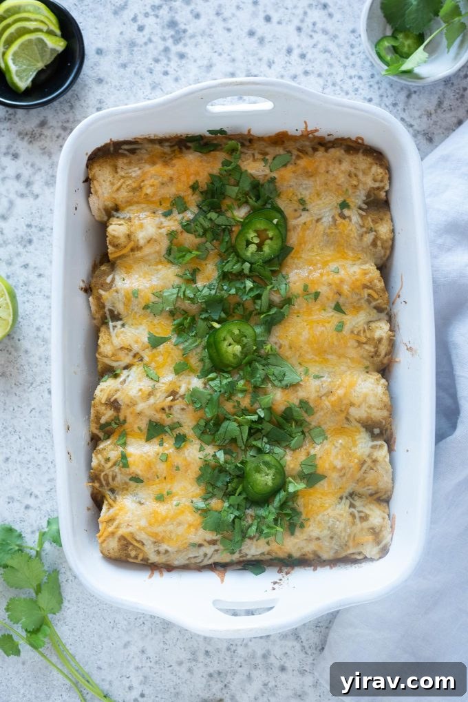 Lean Green Turkey Enchiladas 2 Green enchiladas in a baking dish, ready to be served.