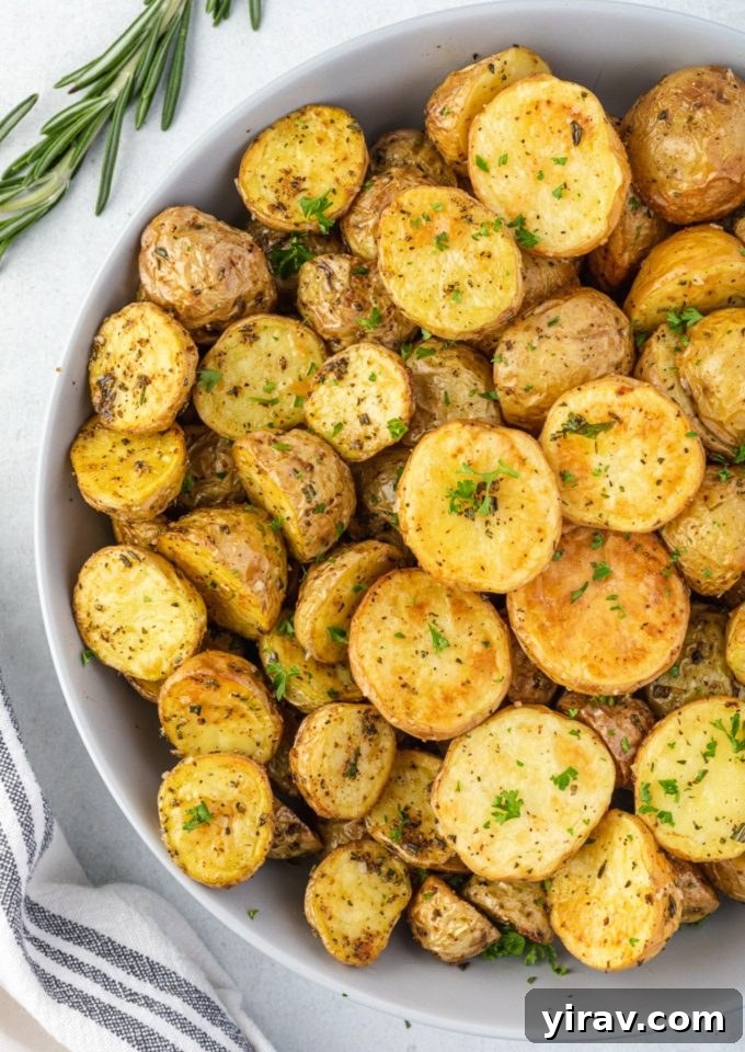 Air fryer potatoes in a bowl with rosemary