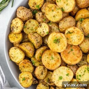 Air fryer potatoes in a bowl with rosemary