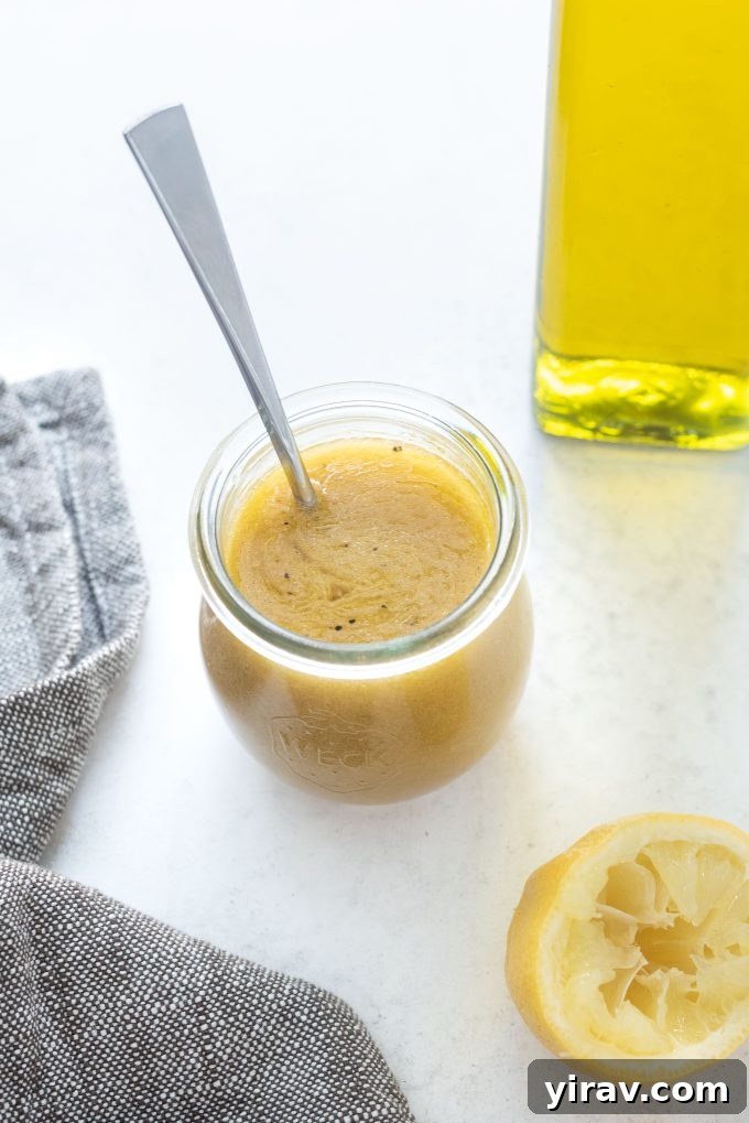 Jar of red wine vinaigrette with spoon in it