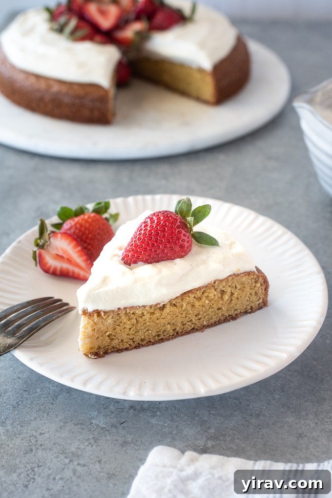Pure Almond Bliss 8 Slice of almond flour cake on a plate with whipped cream and strawberry