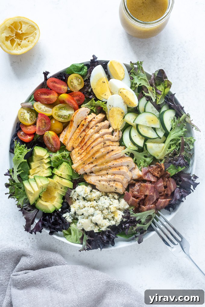 Ultimate Chicken Cobb Salad 6 Chicken cobb salad in a white bowl with a fork