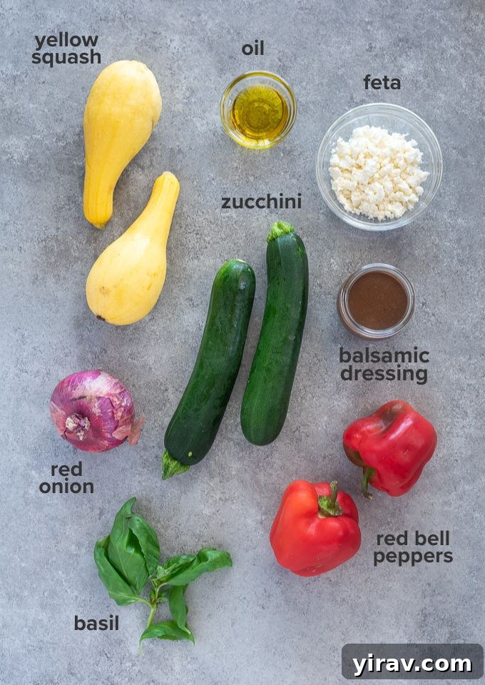 A flat lay of fresh vegetables, feta cheese, and basil, ready to be prepared for grilled vegetable salad.