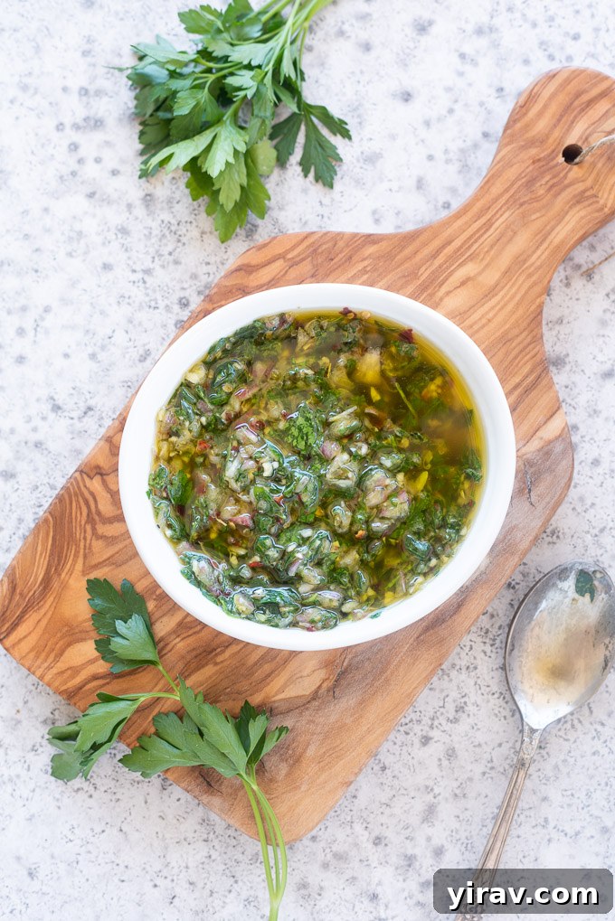 A white bowl filled with green Chimichurri sauce, showcasing its fresh texture.