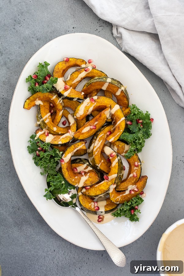 Close-up overhead shot of roasted kabocha squash, indicating a savory dish that pairs well with tahini dressing.