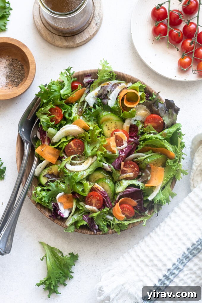 30 Refreshing Summer Salad Ideas 11 Insalata Mista (Italian Mixed Salad) in a serving bowl with wooden servers.