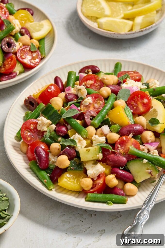 30 Refreshing Summer Salad Ideas 32 Mediterranean Bean Salad elegantly presented on a plate.