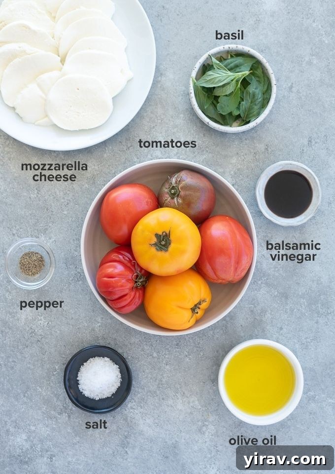 Simple Caprese Perfection 4 Caprese salad ingredients laid out: fresh tomatoes, mozzarella cheese, basil leaves, olive oil, and balsamic vinegar