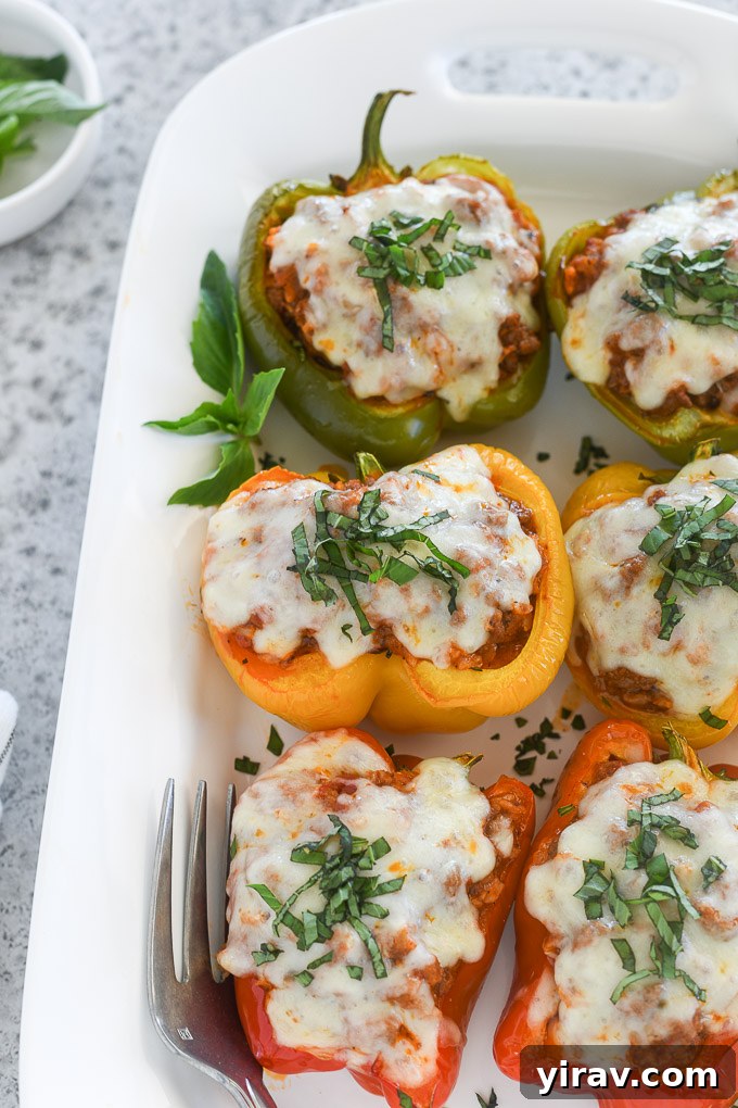 Italian stuffed peppers on a serving platter with basil