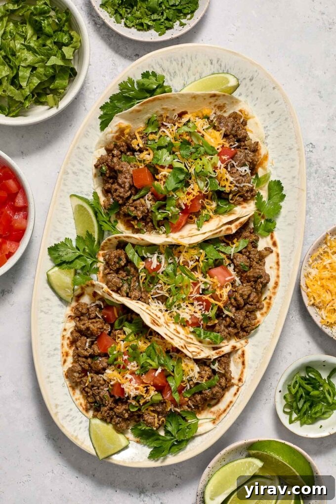 A vibrant platter of easy ground beef tacos, garnished with fresh cilantro and lime wedges, ready to be served.