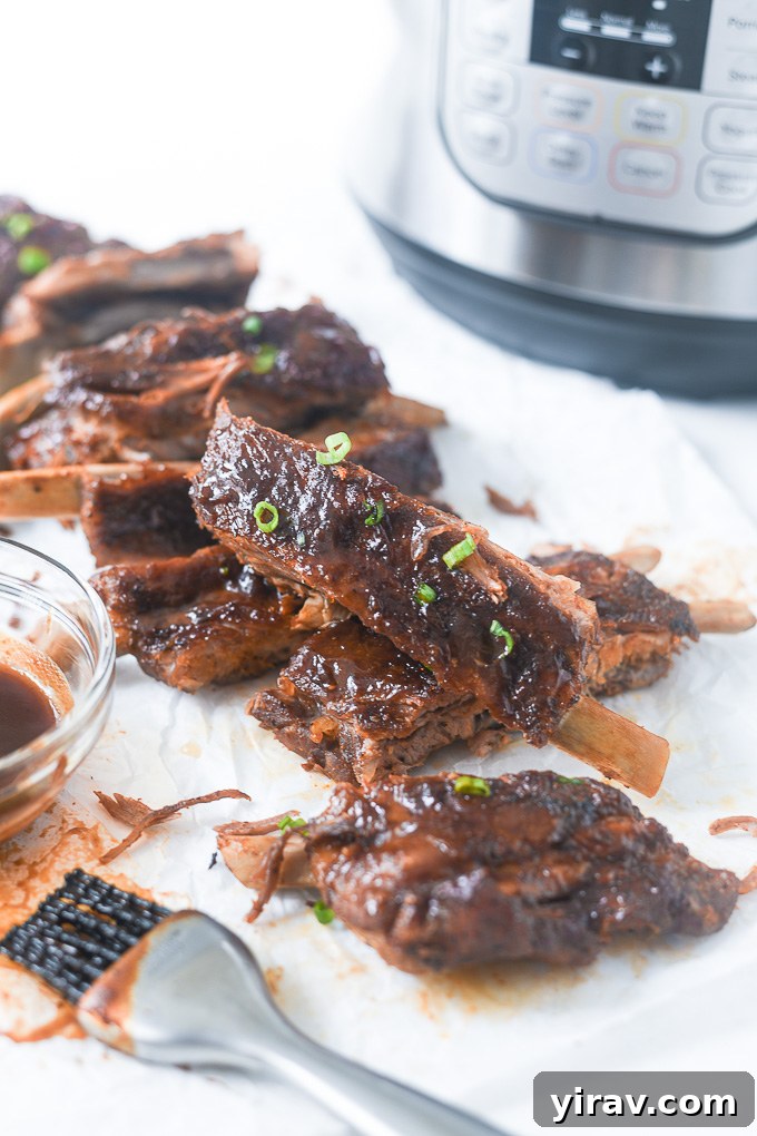 Cooked Instant Pot spare ribs placed in front of the pressure cooker, ready for serving.
