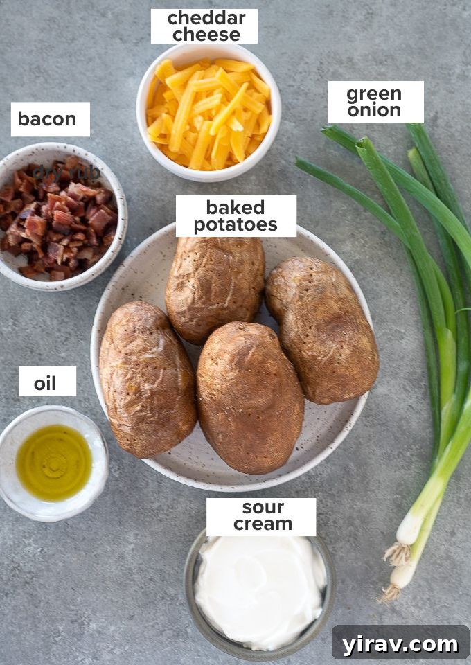 Ingredients laid out for loaded potato skins, including russet potatoes, cheddar cheese, cooked bacon, sour cream, and green onions
