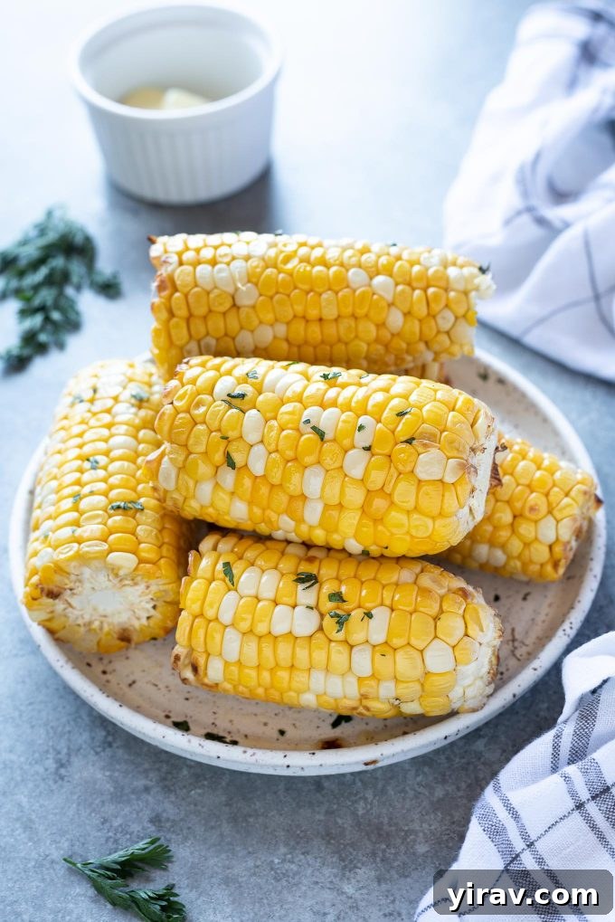 Air Fryer Magic: 15+ Effortless Meals 19 Air fryer corn on the cob piled on a white plate
