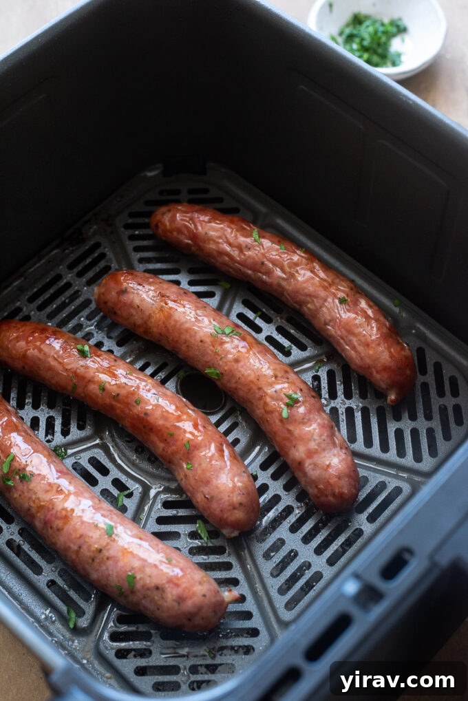 Air Fryer Magic: 15+ Effortless Meals 13 Air fried sausage in air fryer basket.