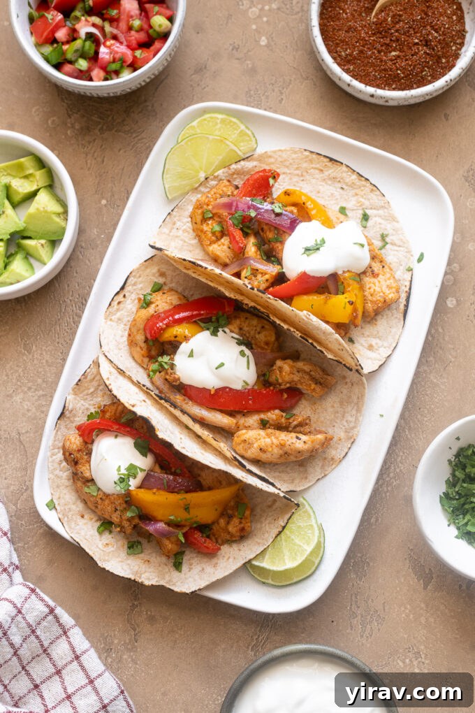 Air Fryer Magic: 15+ Effortless Meals 8 Air fryer chicken fajitas on a platter with toppings.