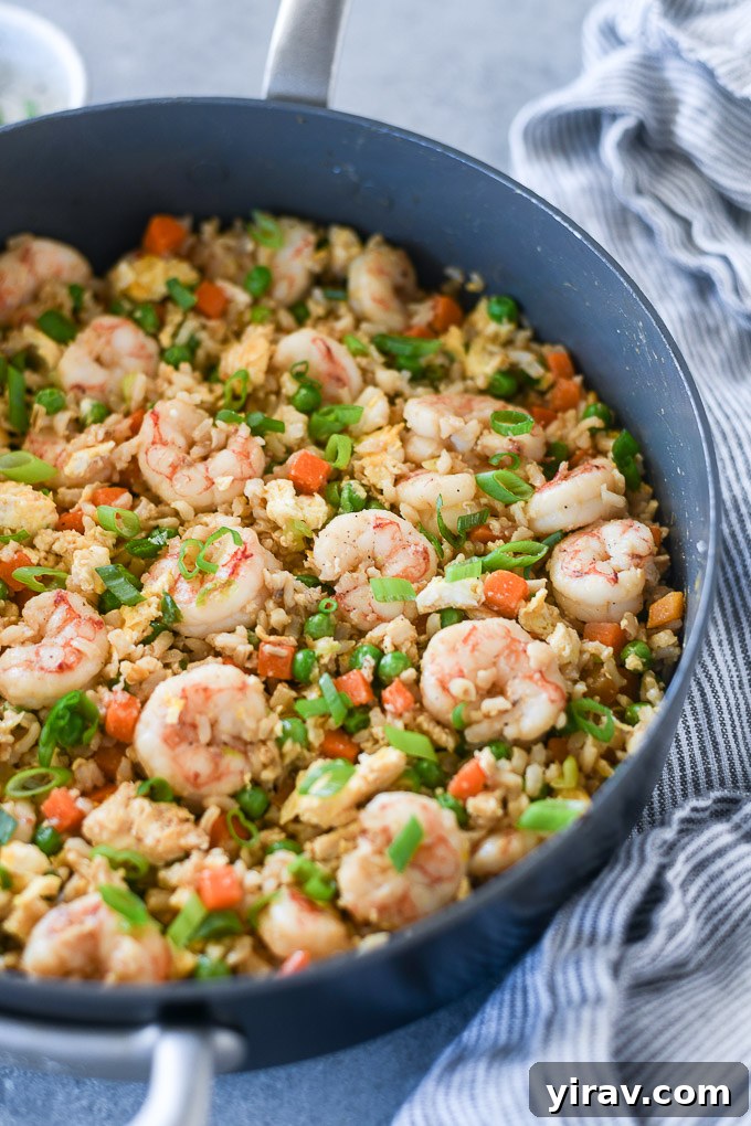 Shrimp fried rice in a pan with a decorative linen napkin