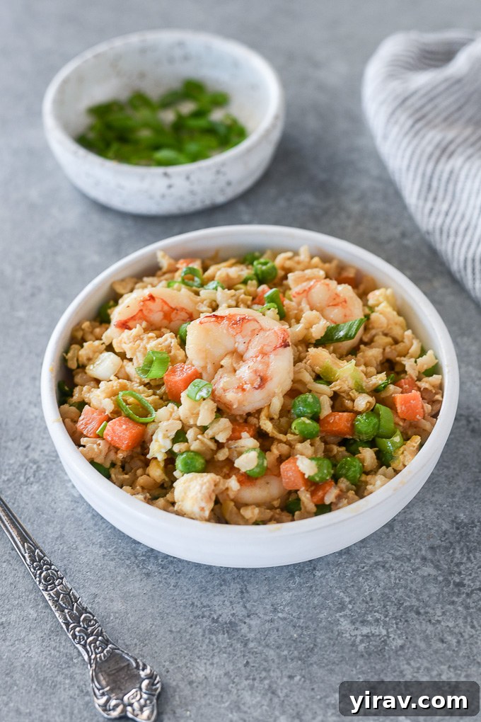 Shrimp fried rice in a white bowl, ready to be served