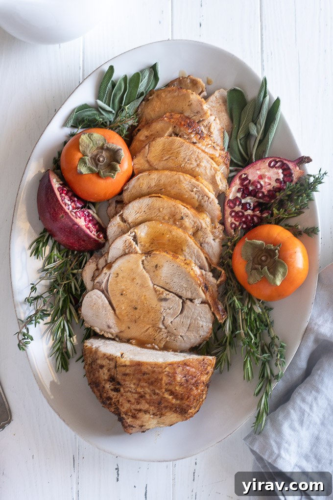 Generous slices of roasted boneless turkey breast lavishly coated in homemade gravy, ready to be served.
