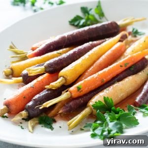 Maple glazed carrots on a platter with fresh parsley