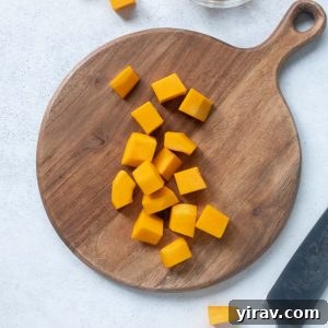 Cubed butternut squash on a cutting board, ready for cooking.
