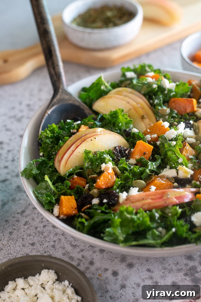 A salad server digging into a fresh Fall Harvest Salad, showing the generous portions and the inviting mix of ingredients, ready for enjoyment.