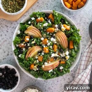 fall harvest salad in a bowl with toppings alongside