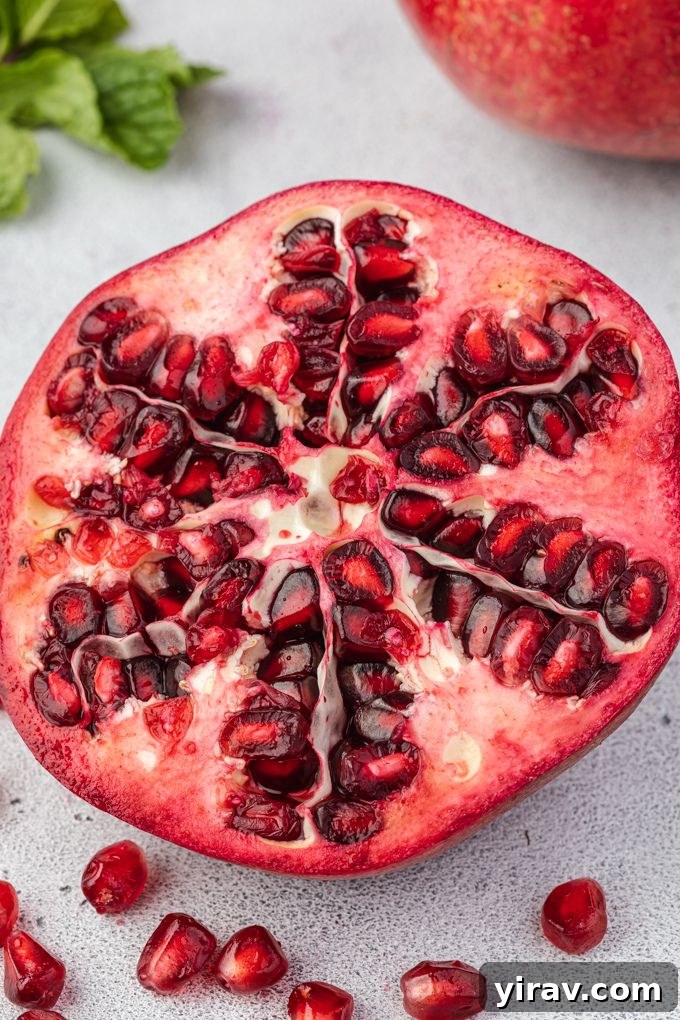 Half of a pomegranate with arils around it