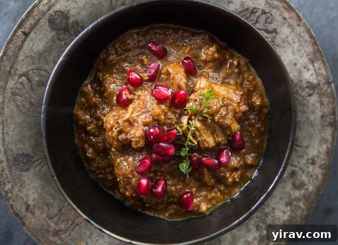 A rich Fesenjan (Persian Pomegranate Chicken) stew, featuring slow-cooked chicken with walnuts and pomegranate molasses.